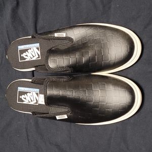 Black VANS mules.